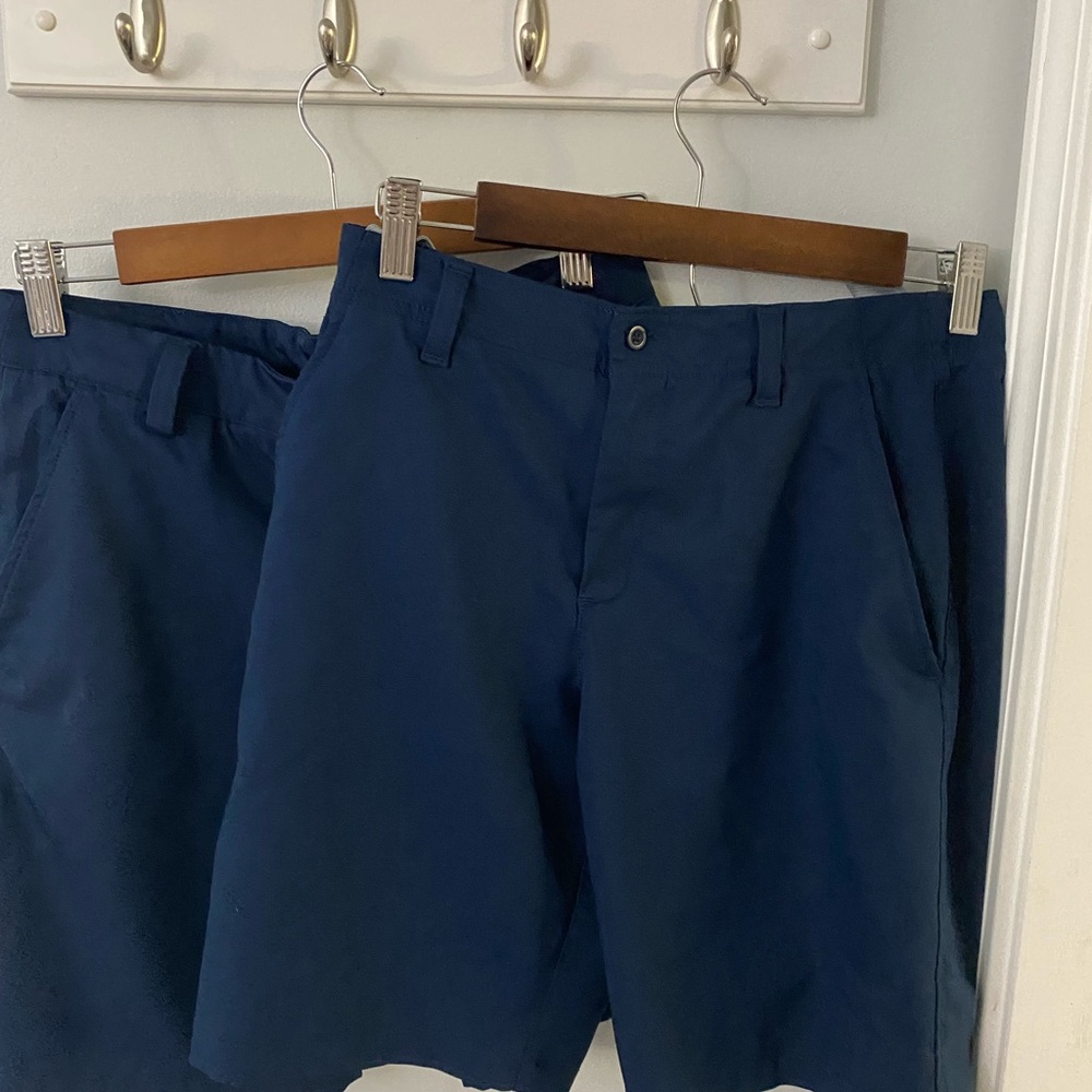 A bundle of two pairs of Underarmour Navy Blue Youth Large shorts.